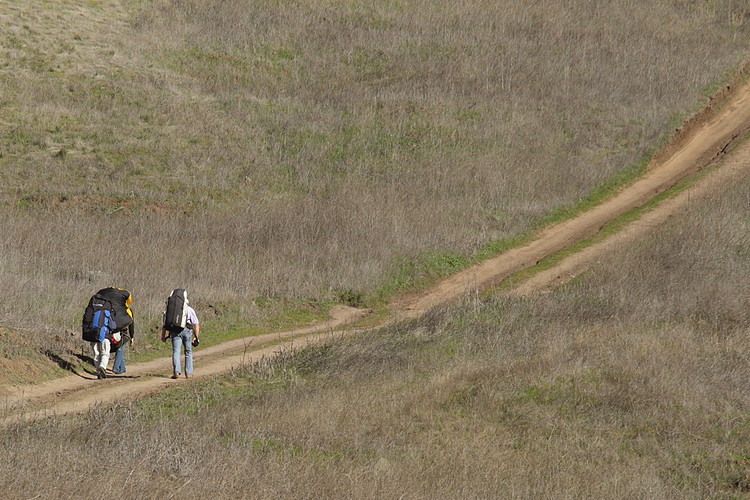 Paragliders hike to the launch point