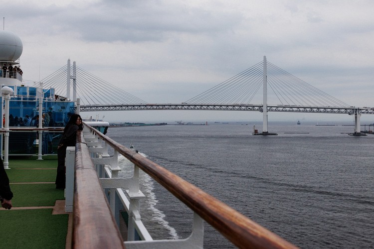 Diamond Princess sailing under the Yokohama Bay Bridge