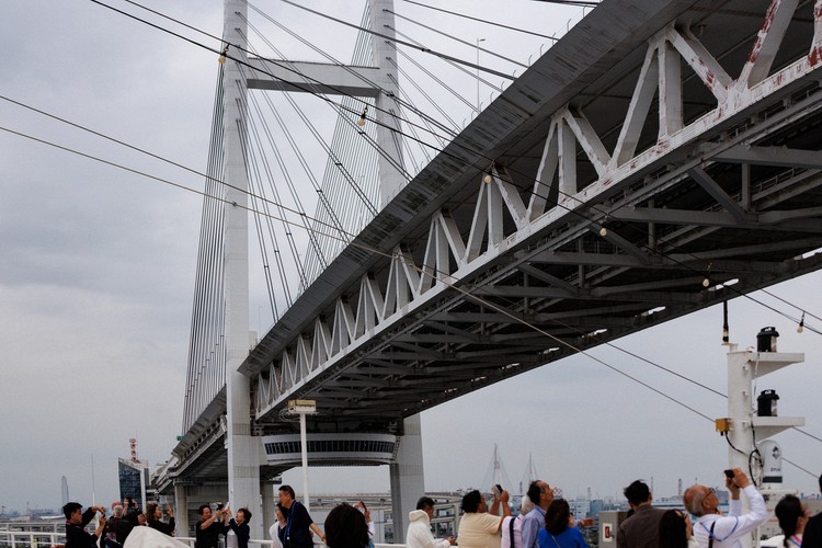 Diamond Princess sailing under the Yokohama Bay Bridge